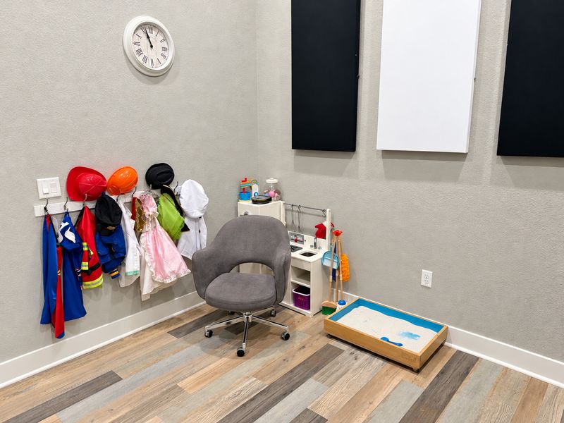 Frisco playroom with dress-up costumes, a play kitchen and a sand tray